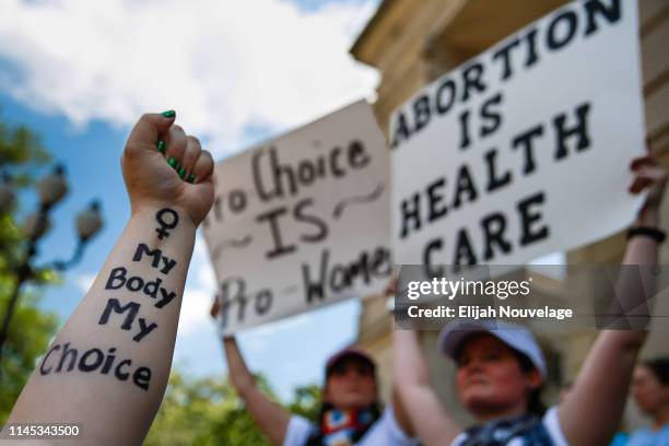 Melissa Simpson holds up her arm with "My Body My Choice" written on it during a protest against recently passed abortion ban bills at the Georgia...