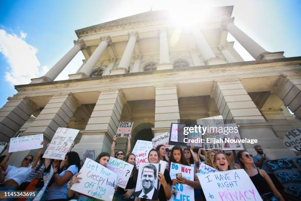 Young women from Paideia High School hold signs during a protest against recently passed abortion ban bills at the Georgia State Capitol building, on...