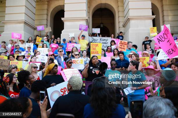 Woman speaks during a protest against recently passed abortion ban bills at the Georgia State Capitol building, on May 21, 2019 in Atlanta, Georgia....