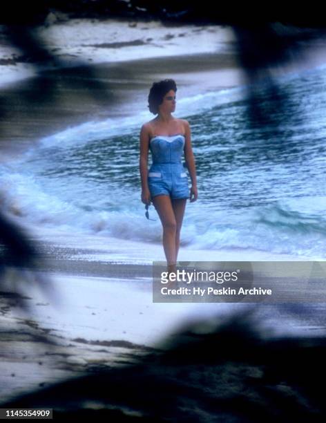 General view of a woman walking along the beach on April 28, 1956 in Green Turtle Cay, Abaco, Bahamas.