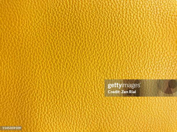 vibrant yellow colored textured material part of a handbag - leder textur stock-fotos und bilder