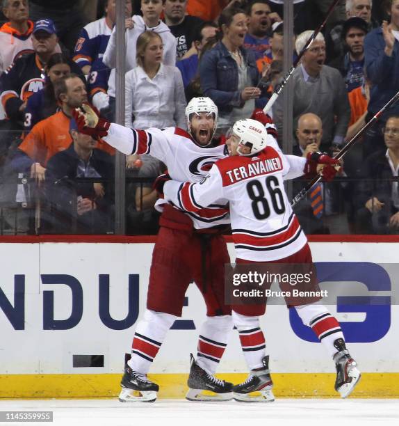 Jordan Staal of the Carolina Hurricanes scores at 4:04 of overtime against the New York Islanders and is joined by Teuvo Teravainen in Game One of...