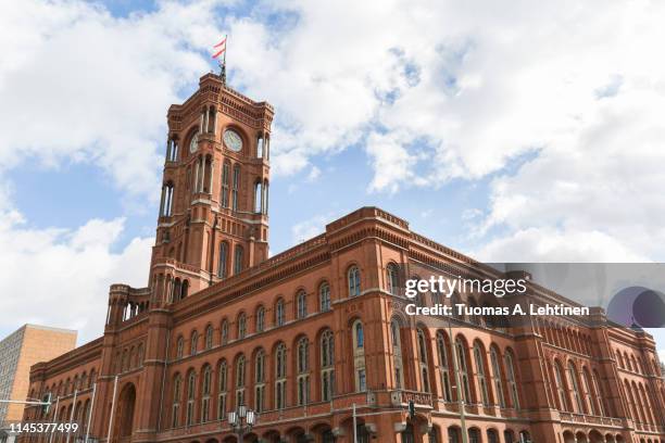 view of the berlin's town hall, rotes rathaus (red city hall), and its clock tower in germany, on a sunny day. - rathaus stock pictures, royalty-free photos & images