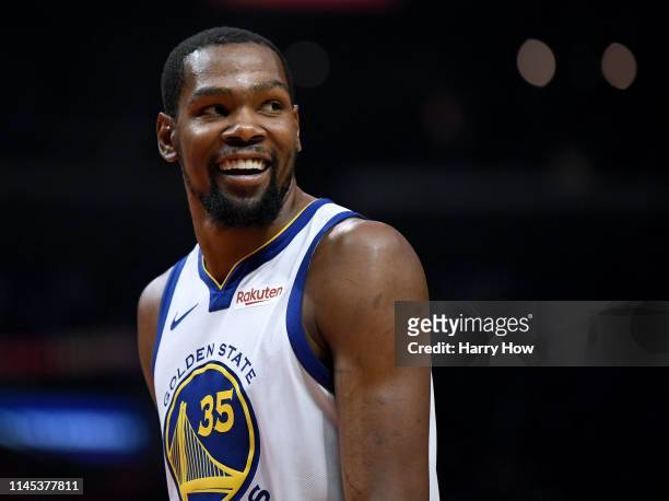 Kevin Durant of the Golden State Warriors smiles at his bench in a 129-110 win over the LA Clippers during Game Six of Round One of the 2019 NBA...
