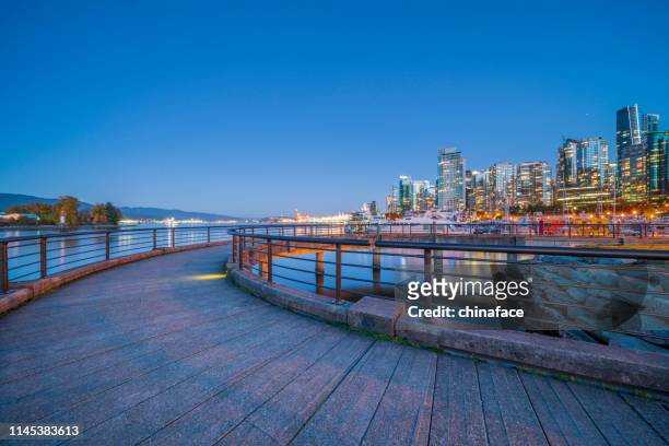 city skyline and marina of vancouver from stanley park - vancouver stock pictures, royalty-free photos & images