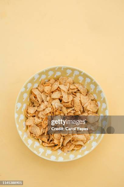 corn flakes in yellow bowl - bowl of cereal stock pictures, royalty-free photos & images