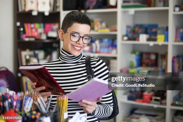 student buying school supplies - buying school supplies stock pictures, royalty-free photos & images