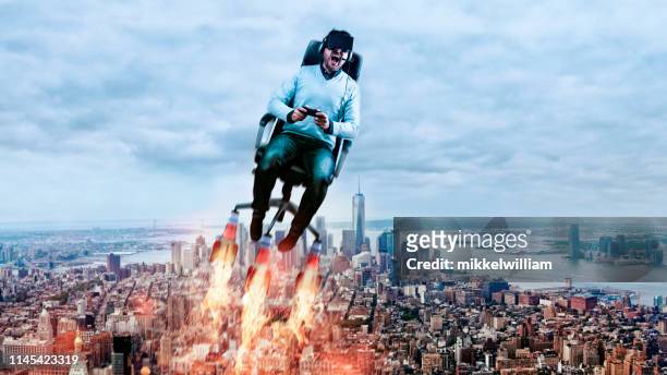 concept of virtual reality with man wearing 3d-glasses and flying through the air - rockets game stock pictures, royalty-free photos & images