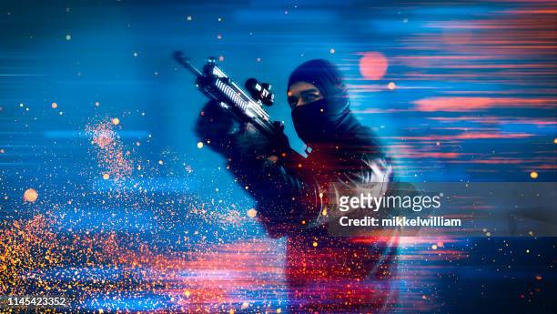 soldier or criminal from video game holds a machine gun and aims at a target - terrorism stock pictures, royalty-free photos & images