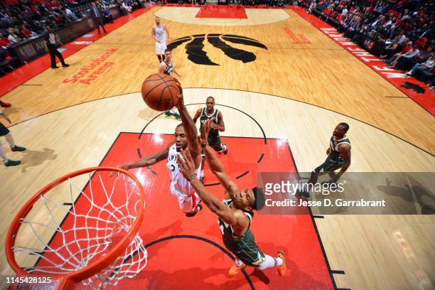 Kawhi Leonard of the Toronto Raptors dunks the ball against Giannis Antetokounmpo of the Milwaukee Bucks during Game Four of the Eastern Conference...