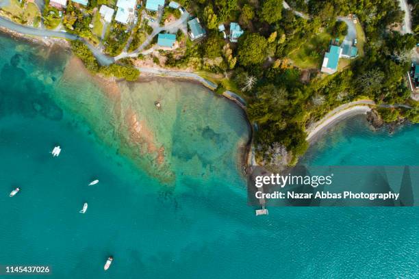 looking down at samll town along the beach. - northland region stock pictures, royalty-free photos & images