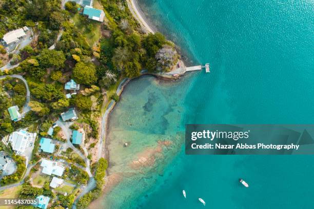 looking down at samll town along the beach. - northland region stock pictures, royalty-free photos & images