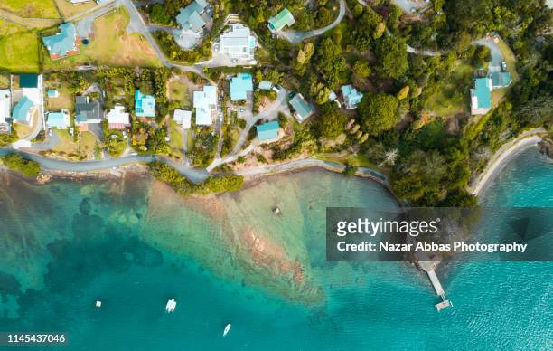 looking down at samll town along the beach. - bay of islands new zealand stock pictures, royalty-free photos & images