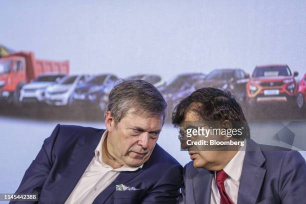Guenter Butschek, chief executive officer of Tata Motors Ltd., left, listens to Mayank Pareek, president of passenger vehicles, during an earnings...