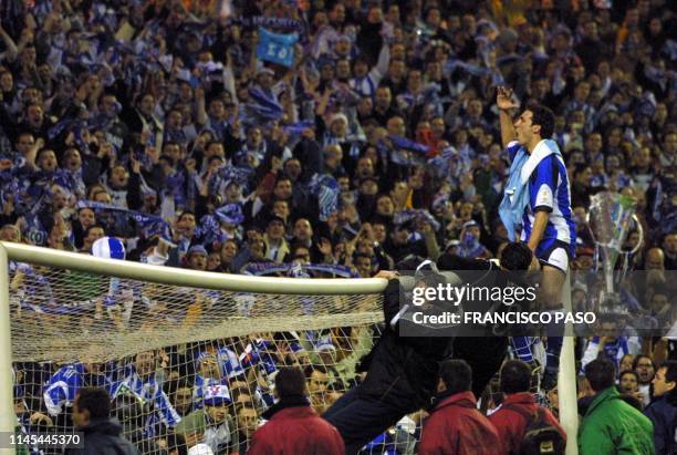 Deportivo's Argentine player Lionel Scaloni celebrates on the top of the goal after his team won the final of the 100th Copa del Rey against Real...