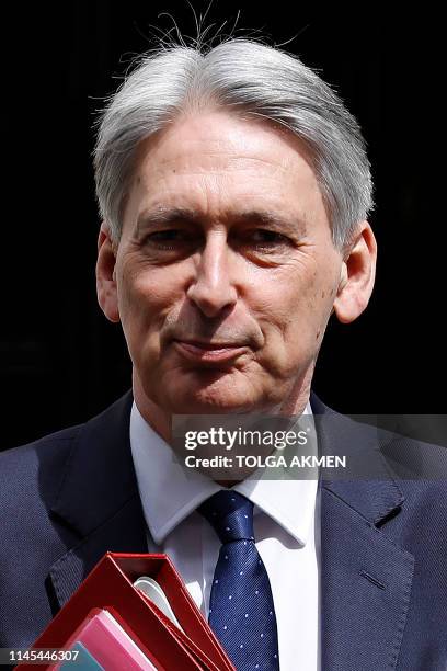 Britain's Chancellor of the Exchequer Philip Hammond leaves from 11 Downing Street in London on May 22 ahead of the weekly Prime Minister's Questions...