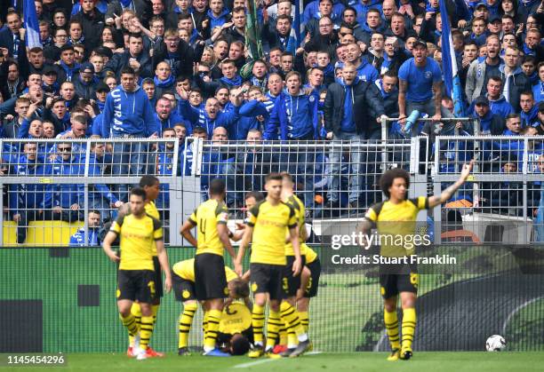 Schalke 04 fans react towards Borussia Dortmund players as they celebrate after scoring their first goal during the Bundesliga match between Borussia...