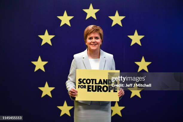 Nicola Sturgeon, SNP leader and First Minister of Scotland stands with a placard during day one of the SNP Spring Conference at the Edinburgh...