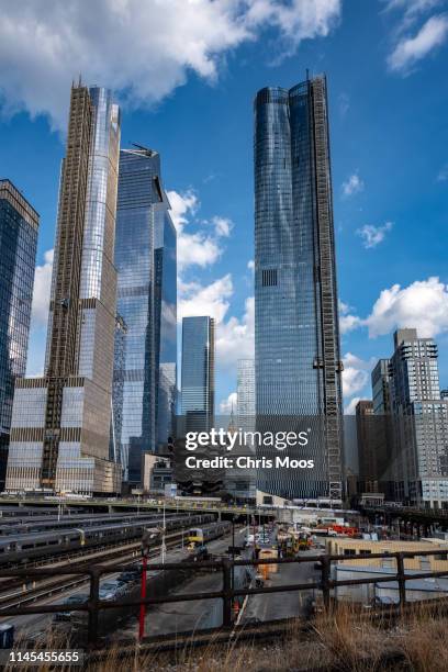 view across hudson yards development showing new skyscrapers and vessel sculpture on sunny day in new york city - moos sculpture stock pictures, royalty-free photos & images