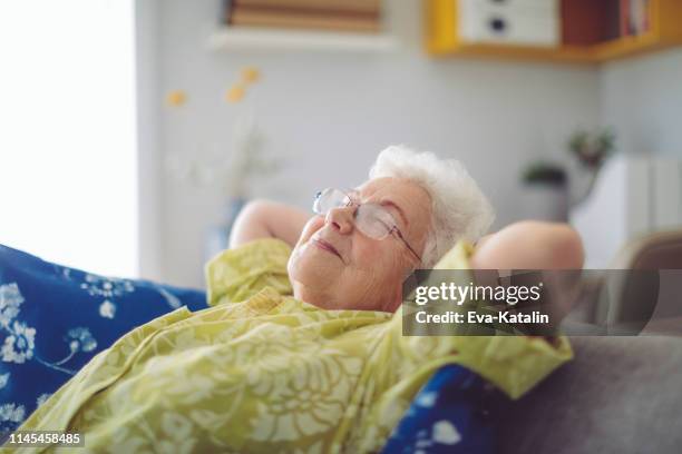senior woman at home - comfortable sleeping stock pictures, royalty-free photos & images