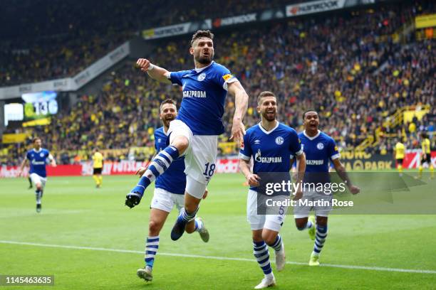 Daniel Caligiuri of FC Schalke 04 celebrates after scoring his team's third goal with team mates during the Bundesliga match between Borussia...