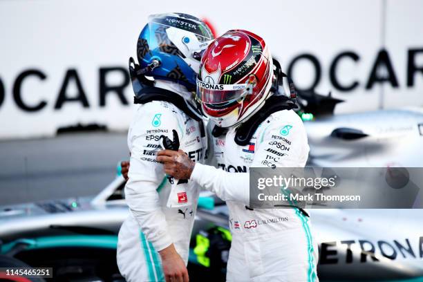 Pole position qualifier Valtteri Bottas of Finland and Mercedes GP celebrates with second place qualifier Lewis Hamilton of Great Britain and...