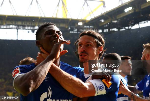 Breel Embolo of FC Schalke 04 celebrates with teammate Benjamin Stambouli after scoring his team's fourth goal during the Bundesliga match between...