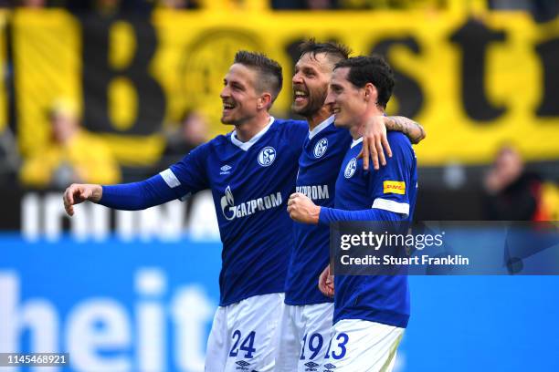 Bastian Oczipka, Guido Burgstaller and Sebastian Rudy of FC Schalke 04 celebrate after the Bundesliga match between Borussia Dortmund and FC Schalke...