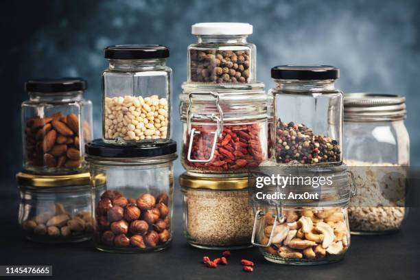 kitchen shelf with jars - hülsenfrucht stock-fotos und bilder