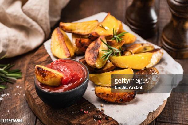 rosemary baked potato wedges with ketchup - fastfood restaurant table stock-fotos und bilder