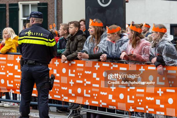 dutch policeman in uniform are active during koningsdag in amersfoort-2019 - koninginnedag stock pictures, royalty-free photos & images