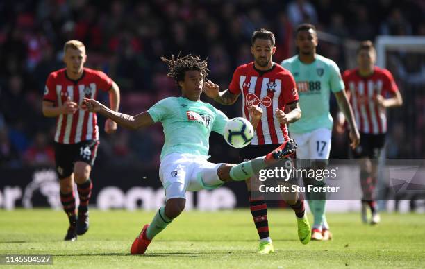 Bournemouth player Nathan Ake is challenged by Danny Ings during the Premier League match between Southampton FC and AFC Bournemouth at St Mary's...