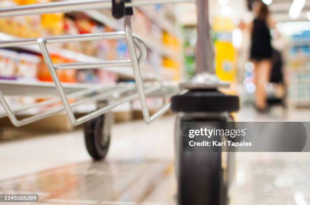 a low angle view of a pushcart - shopping trolleys stockfoto's en -beelden