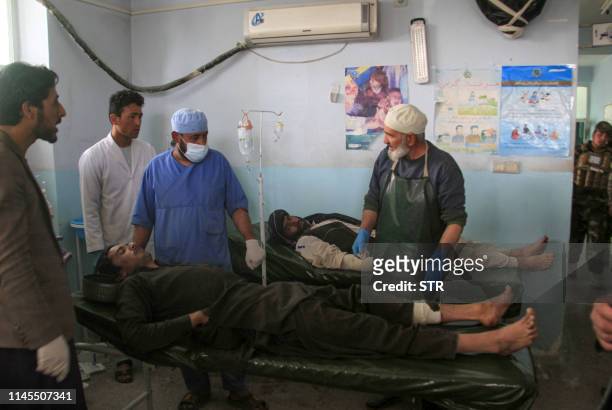 Afghan injured men receive medical treatment at a hospital following a suicide bomber attack with explosives packed in a vehicle in Ghazni province...