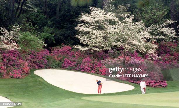 Defending Masters champion Bernhard Langer of Germany hits from the sand on the thirteenth hole 06 April 1994 in the famous "Amen Corner" of the...