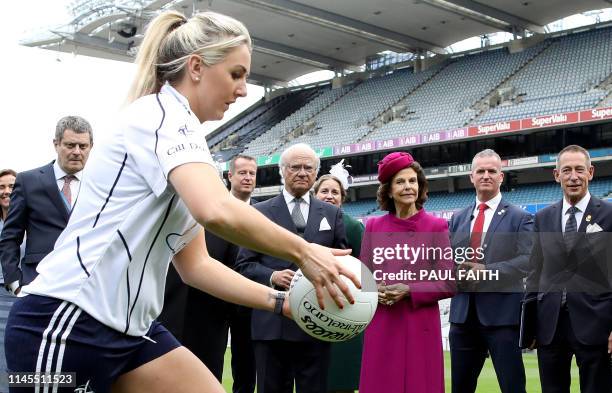 Sweden's King Carl XVI Gustaf reacts as he and his wife Queen Silvia watch a Gaelic football demonstration at Croke Park, the home of the Gaelic...