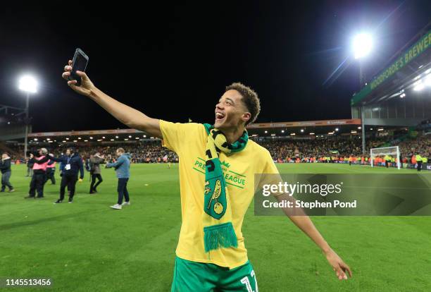 Jamal Lewis of Norwich City celebrates as his team secure promotion to the Premier League following their victory in the Sky Bet Championship match...