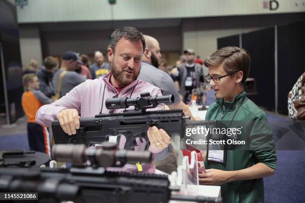 Guests shop for firearms and accessories at the 148th NRA Annual Meetings & Exhibits on April 27, 2019 in Indianapolis, Indiana. The convention,...