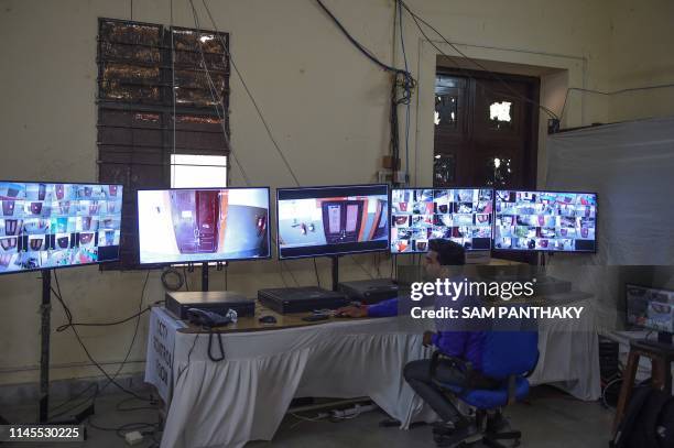 An Indian official monitors screens at a CCTV Control Room at a counting centre on the eve of vote counting day of India's general election in...