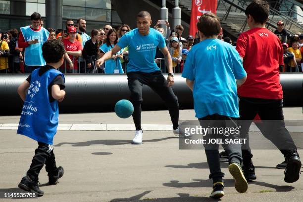 Paris Saint-Germain's French forward Kylian Mbappe takes part in a football match with children from the 'Premiers de Cordee' Association at the...