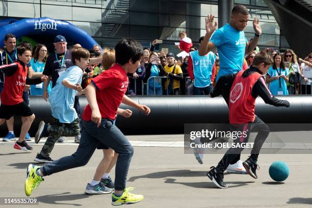 Paris Saint-Germain's French forward Kylian Mbappe takes part in a football match with children from the 'Premiers de Cordee' Association at the...