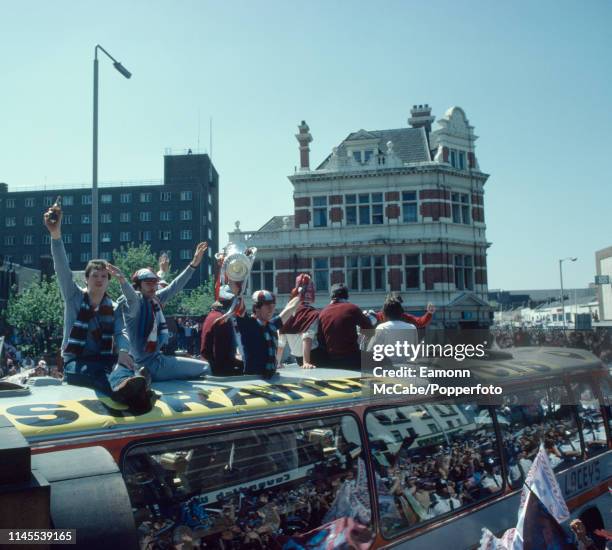 West Ham United players on top of the bus during the parade of the trophy around East London after their team won the FA Cup Final on May 11, 1980 in...