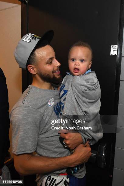 Stephen Curry of the Golden State Warriors looks on with his son after advancing to the NBA Finals against the Portland Trail Blazers during Game...