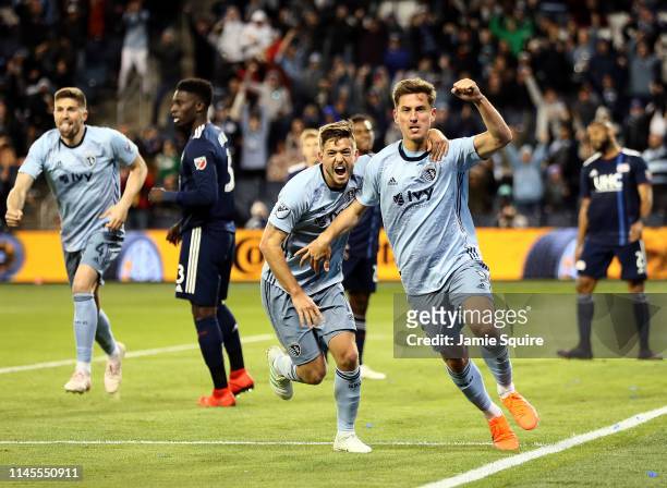 Krisztian Nemeth of Sporting Kansas City celebrates with Kelyn Rowe after scoring during the second half of the game against the New England...