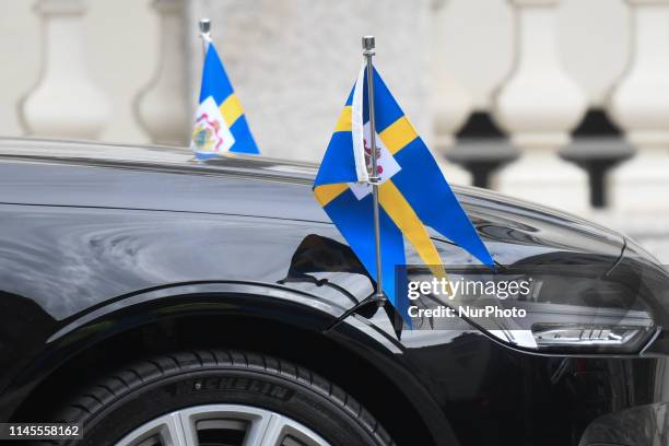 Flags of the Monarchy of Sweden seen on the car carrying King Carl XVI Gustaf and Queen Silvia of Sweden, on Day One of their visit to to the...