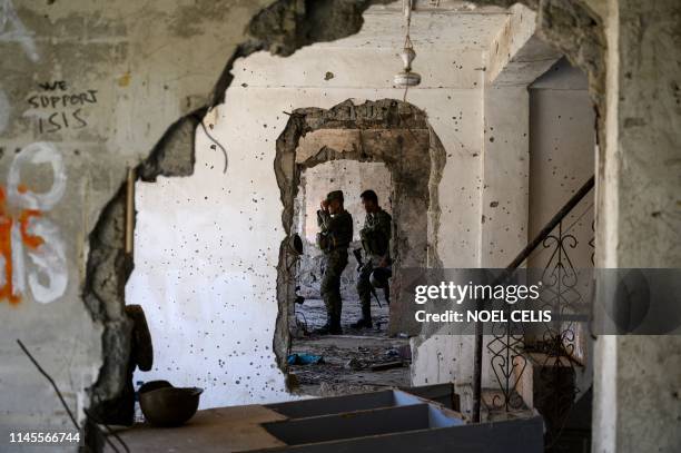 Soldiers walk inside a destroyed building in Marawi on the southern island of Mindanao on May 23, 2019. Two years after the Philippine city of Marawi...