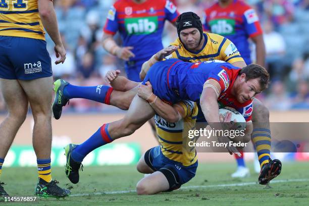 Tim Glasby of the Newcastle Knights is tackled during the round 7 NRL match between the Newcastle Knights and Parramatta Eels at McDonald Jones...