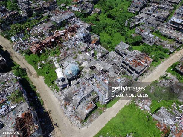 This aerial photo shows a destroyed mosque in Marawi on the southern island of Mindanao May 23, 2019. - Two years after the Philippine city of Marawi...