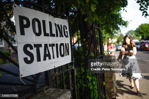 Woman arrives to vote at a polling station on May 23, 2019 in Twickenham, United Kingdom. Polls opened today for European elections. Polls are open...