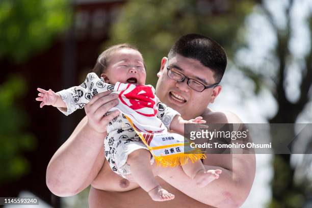 Baby, held by a sumo wrestler, cries during the Nakizumo or Naki Sumo Baby Crying contest at Sensoji Temple on April 28, 2019 in Tokyo, Japan. 160...